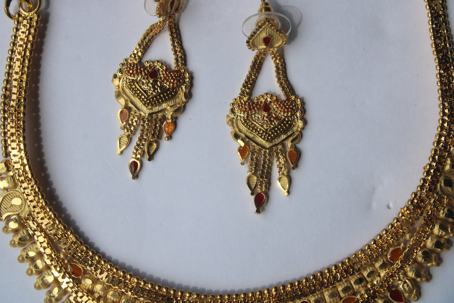 Unique And Trendy Gold-Toned Necklace with Intricate Red & Yellow Stone Accents – Perfect for Festive & Bridal Wear